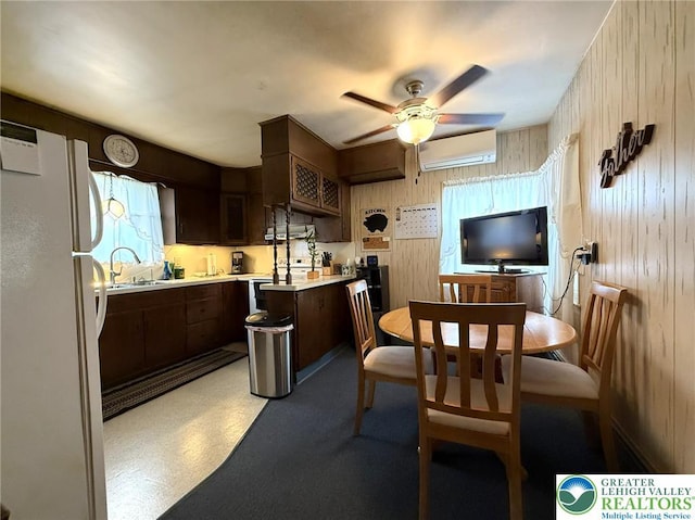 619 Penn Dr, West Penn Twp, PA 18252 - kitchen with freestanding refrigerator, an AC wall unit, light countertops, a ceiling fan, and dark brown cabinets