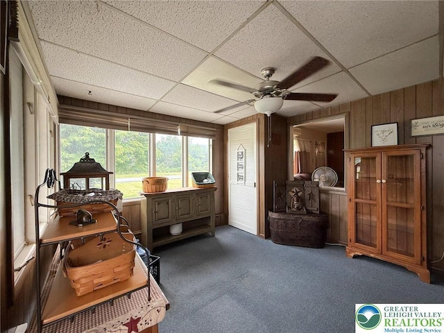 619 Penn Dr, West Penn Twp, PA 18252 - sitting room featuring wooden walls, ceiling fan, a paneled ceiling, and carpet