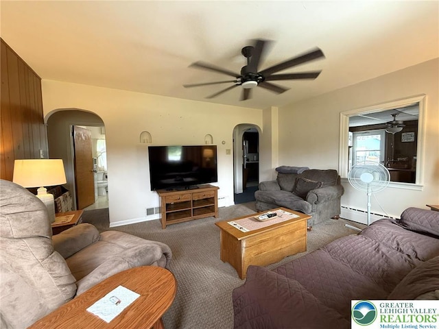 619 Penn Dr, West Penn Twp, PA 18252 - living room with arched walkways, ceiling fan, carpet flooring, and a baseboard heating unit