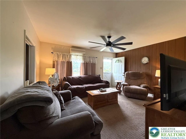 619 Penn Dr, West Penn Twp, PA 18252 - living room with carpet flooring, a wall mounted AC, wooden walls, and ceiling fan