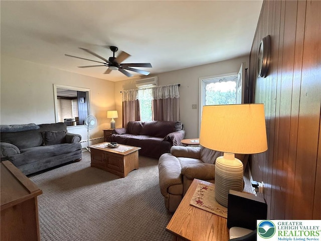 619 Penn Dr, West Penn Twp, PA 18252 - living area featuring a baseboard radiator, an AC wall unit, ceiling fan, carpet floors, and wooden walls
