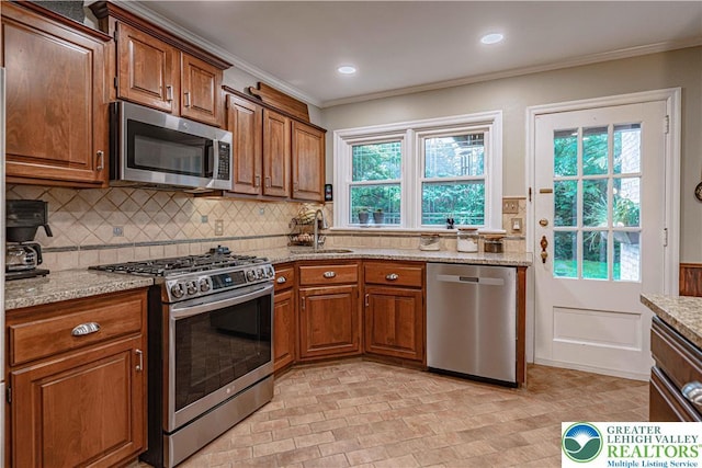 326 N Main St, Allentown City, PA 18104 - kitchen with stainless steel appliances, crown molding, light stone counters, decorative backsplash, and brown cabinets