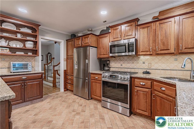 326 N Main St, Allentown City, PA 18104 - kitchen with stainless steel appliances, crown molding, tasteful backsplash, light stone counters, and brick patterned flooring