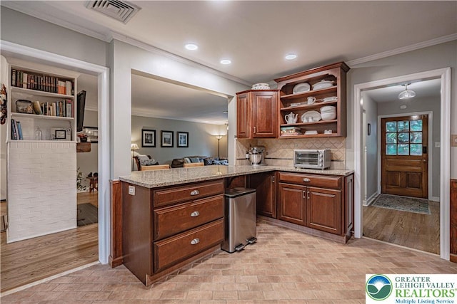 326 N Main St, Allentown City, PA 18104 - kitchen with open shelves, ornamental molding, light stone countertops, tasteful backsplash, and recessed lighting