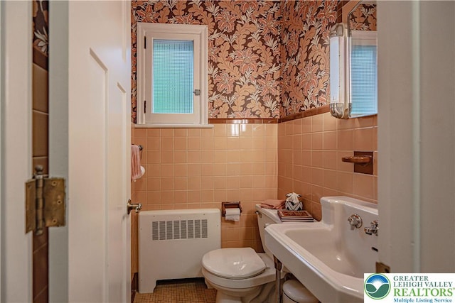 326 N Main St, Allentown City, PA 18104 - bathroom with radiator, wallpapered walls, tile walls, and wainscoting