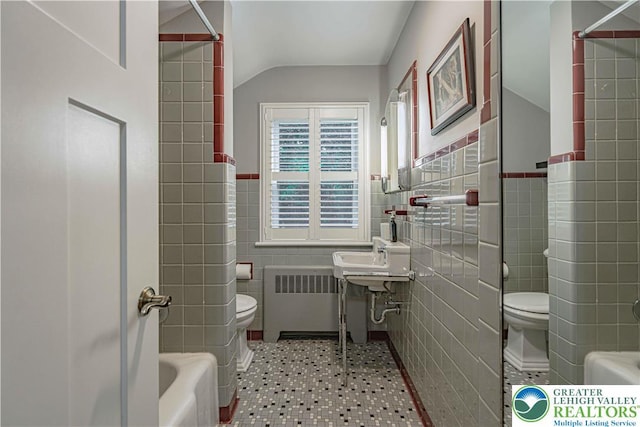 326 N Main St, Allentown City, PA 18104 - full bath with tile walls, radiator, lofted ceiling, tile patterned floors, and a wainscoted wall