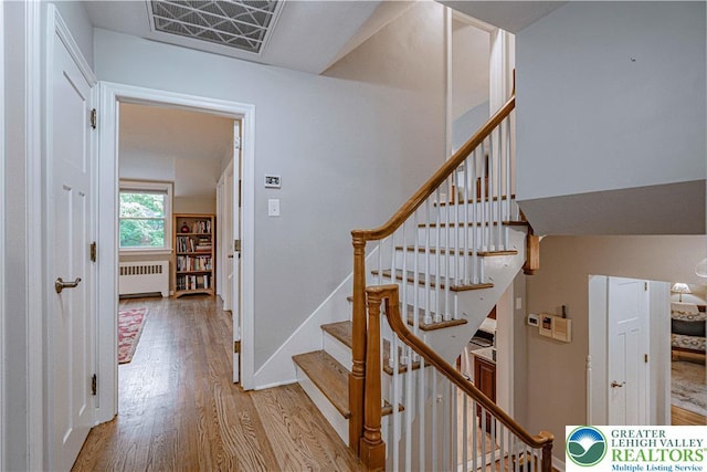 326 N Main St, Allentown City, PA 18104 - stairs featuring radiator heating unit and wood finished floors