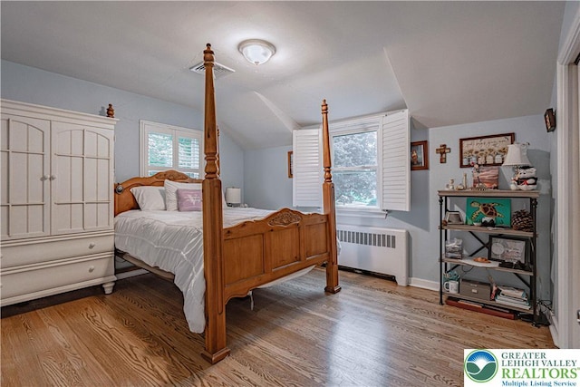 326 N Main St, Allentown City, PA 18104 - bedroom featuring radiator, wood finished floors, and lofted ceiling