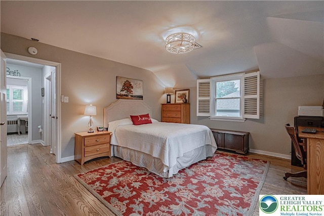 326 N Main St, Allentown City, PA 18104 - bedroom with lofted ceiling, wood finished floors, radiator heating unit, and an office area
