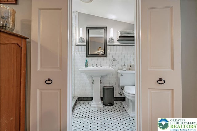 326 N Main St, Allentown City, PA 18104 - bathroom featuring tile patterned floors, tile walls, and vaulted ceiling
