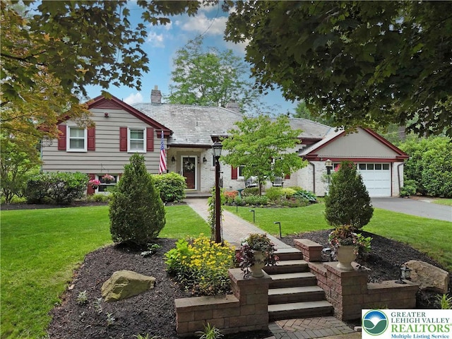 326 N Main St, Allentown City, PA 18104 - split level home with a chimney, a front yard, a garage, and driveway