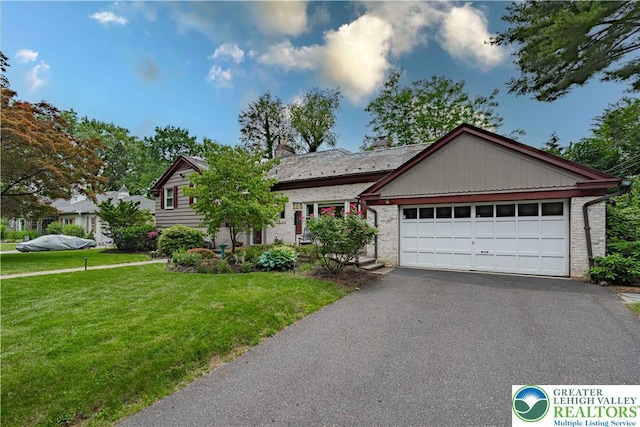 326 N Main St, Allentown City, PA 18104 - view of front facade with driveway, a front yard, an attached garage, and brick siding