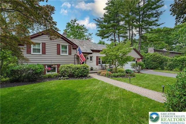 326 N Main St, Allentown City, PA 18104 - tri-level home with a front yard, a chimney, a high end roof, and driveway