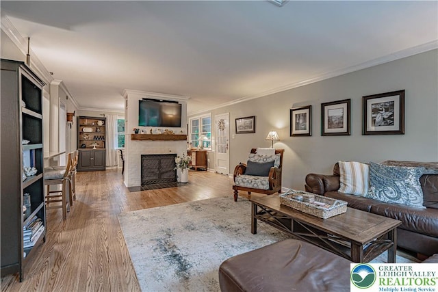 326 N Main St, Allentown City, PA 18104 - living room with crown molding, wood finished floors, and a fireplace with flush hearth
