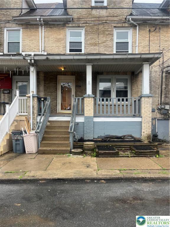 827 Louis St, Easton, PA 18042 - townhome / multi-family property with brick siding and a porch