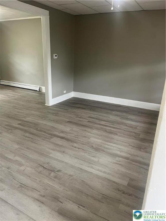 827 Louis St, Easton, PA 18042 - spare room featuring baseboard heating, a paneled ceiling, and wood finished floors