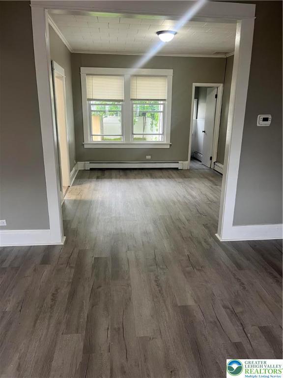 827 Louis St, Easton, PA 18042 - spare room with ornamental molding, a baseboard radiator, and wood finished floors