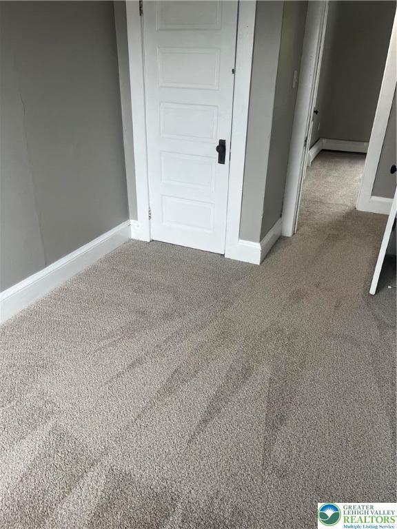 827 Louis St, Easton, PA 18042 - unfurnished room featuring carpet flooring and a baseboard radiator