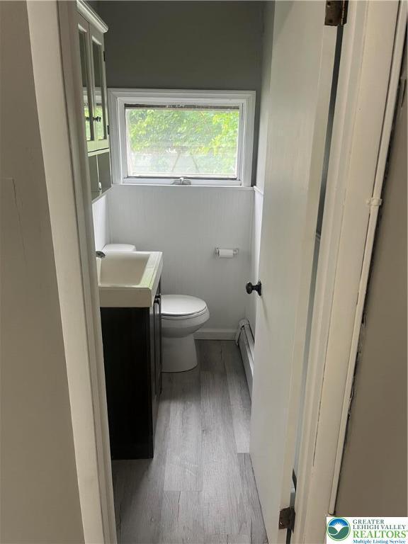 827 Louis St, Easton, PA 18042 - bathroom featuring wood finished floors, vanity, and baseboard heating