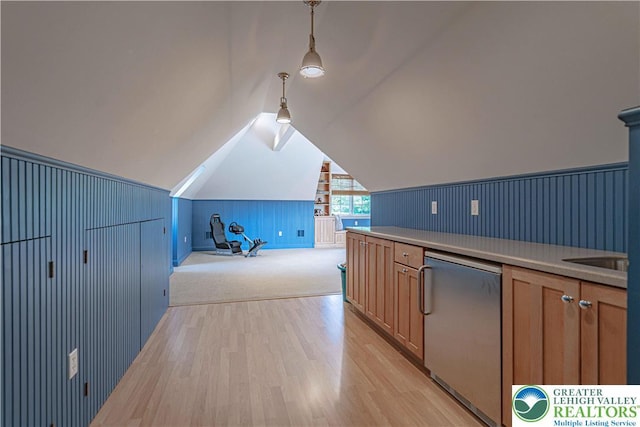 3054 Jordan Rd, North Whitehall Twp, PA 18069 - kitchen featuring light wood-type flooring, light countertops, vaulted ceiling, decorative light fixtures, and stainless steel dishwasher