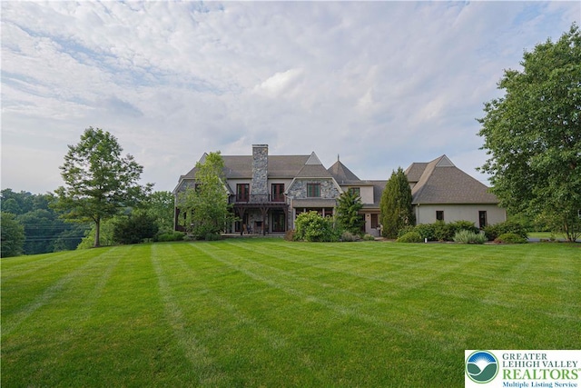 3054 Jordan Rd, North Whitehall Twp, PA 18069 - back of house with stone siding, a yard, and a chimney