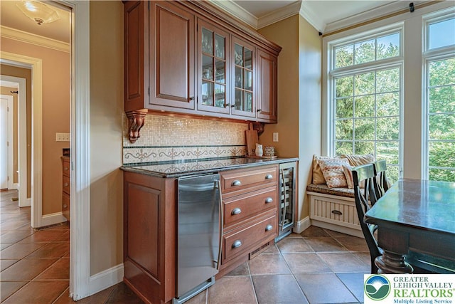 3054 Jordan Rd, North Whitehall Twp, PA 18069 - kitchen with tasteful backsplash, brown cabinetry, crown molding, glass insert cabinets, and light tile patterned flooring