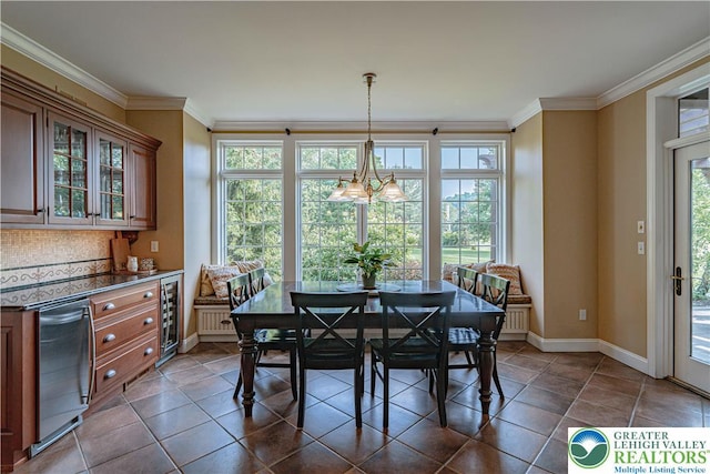 3054 Jordan Rd, North Whitehall Twp, PA 18069 - dining area featuring wine cooler, crown molding, and dark tile patterned floors