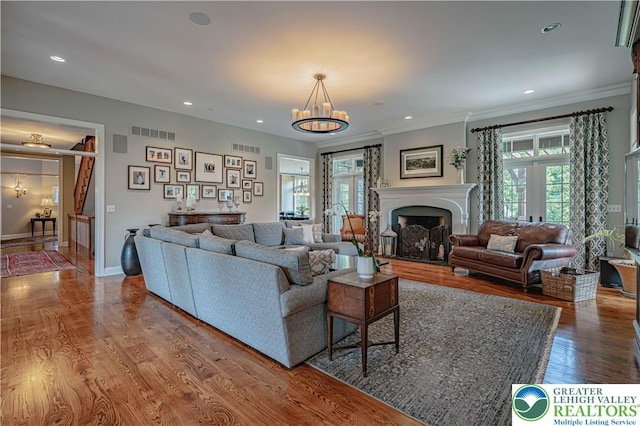 3054 Jordan Rd, North Whitehall Twp, PA 18069 - living area with a chandelier, wood finished floors, ornamental molding, french doors, and recessed lighting