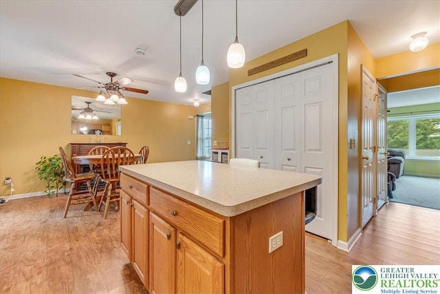 617 Lehigh Gap St, Walnutport Boro, PA 18088 - kitchen featuring a ceiling fan, light wood-type flooring, a kitchen island, light countertops, and pendant lighting