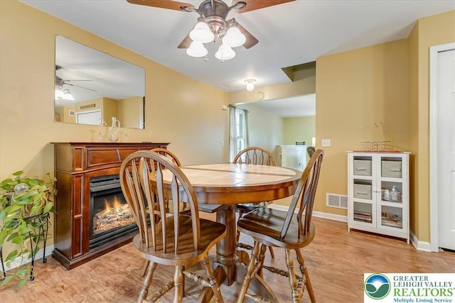 617 Lehigh Gap St, Walnutport Boro, PA 18088 - dining space with ceiling fan, light wood-style floors, and a lit fireplace