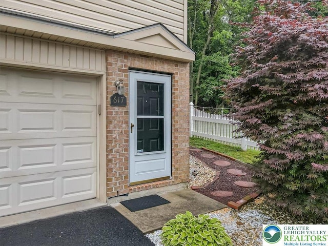 617 Lehigh Gap St, Walnutport Boro, PA 18088 - entrance to property featuring a garage and brick siding