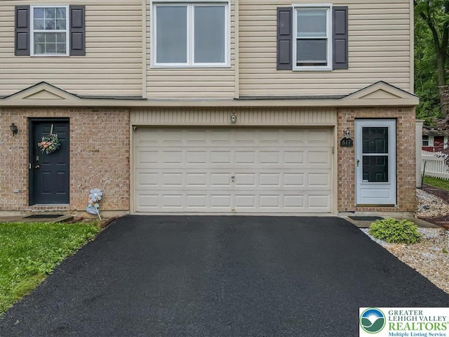 617 Lehigh Gap St, Walnutport Boro, PA 18088 - townhome / multi-family property with asphalt driveway, a garage, and brick siding