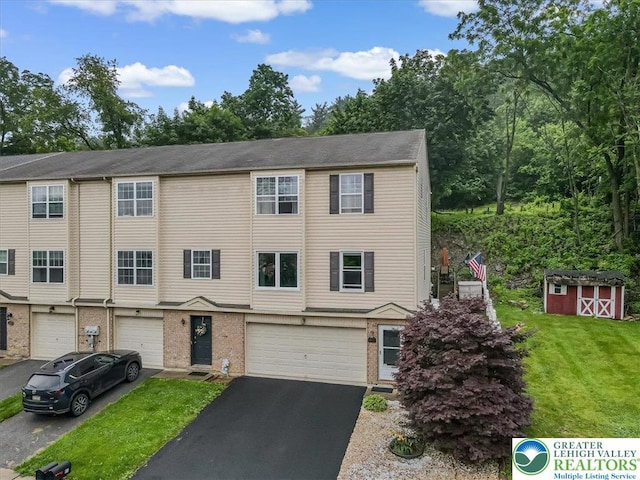 617 Lehigh Gap St, Walnutport Boro, PA 18088 - townhome / multi-family property with a garage, driveway, brick siding, a front lawn, and a storage shed