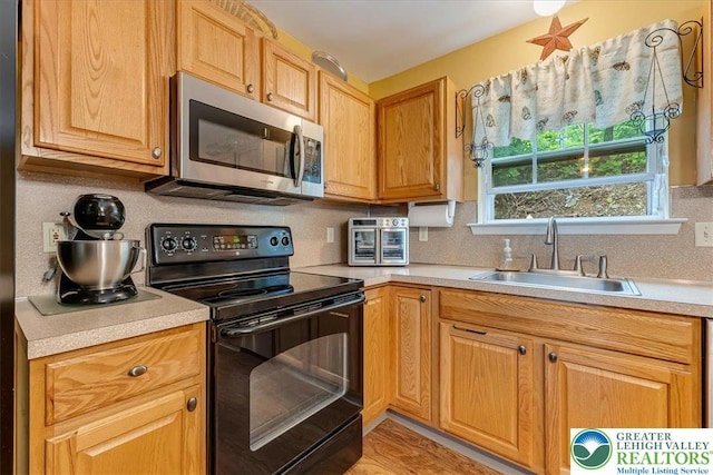 617 Lehigh Gap St, Walnutport Boro, PA 18088 - kitchen with stainless steel microwave, black electric range oven, light countertops, and backsplash