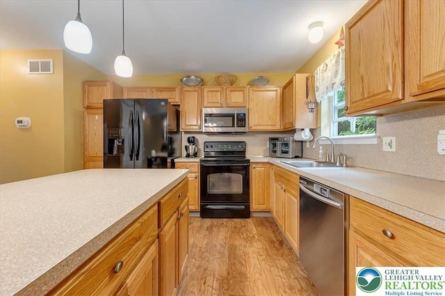 617 Lehigh Gap St, Walnutport Boro, PA 18088 - kitchen with black appliances, light wood finished floors, light countertops, hanging light fixtures, and backsplash