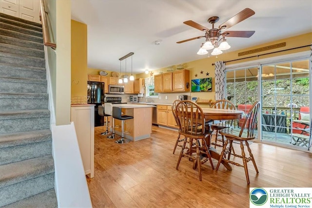 617 Lehigh Gap St, Walnutport Boro, PA 18088 - dining space featuring light wood-style floors, stairway, and ceiling fan