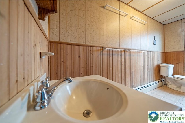 20 N 3rd St, Coplay Boro, PA 18037 - bathroom with a baseboard radiator, wainscoting, wooden walls, and tile patterned flooring
