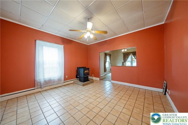20 N 3rd St, Coplay Boro, PA 18037 - tiled spare room featuring ornamental molding, plenty of natural light, a ceiling fan, a wood stove, and baseboard heating