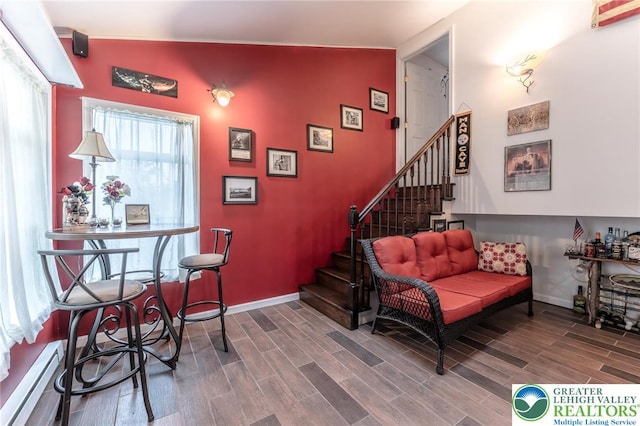 3195 Audubon St, Palmer Twp, PA 18045 - living room featuring stairway, wood finished floors, an accent wall, and a baseboard heating unit