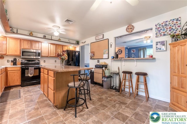 3195 Audubon St, Palmer Twp, PA 18045 - kitchen featuring black appliances, ceiling fan, a kitchen breakfast bar, and a kitchen island