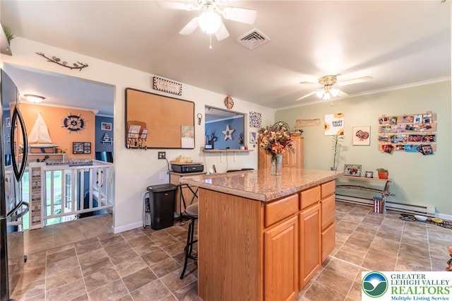 3195 Audubon St, Palmer Twp, PA 18045 - kitchen featuring a ceiling fan, freestanding refrigerator, a center island, a breakfast bar area, and crown molding