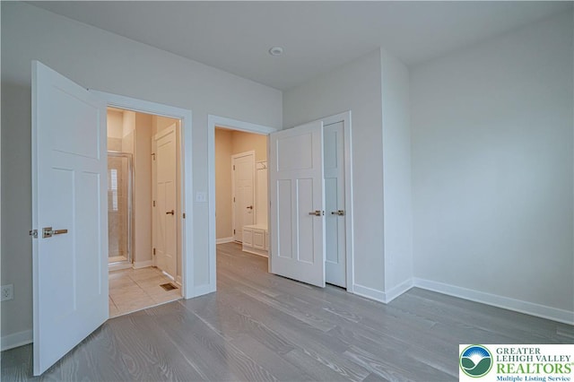 3610 Sweet Meadow Ct, Macungie Boro, PA 18062 - unfurnished bedroom with wood finished floors, a closet, and ensuite bathroom