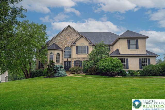 6532 Forest Knoll Ct, Upper Macungie Twp, PA 18106 - view of front of house with a front yard, stucco siding, and stone siding