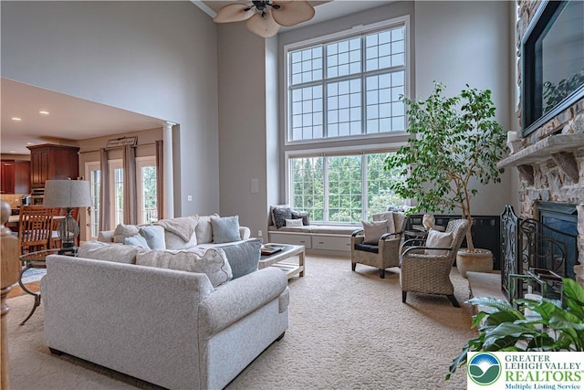 6532 Forest Knoll Ct, Upper Macungie Twp, PA 18106 - carpeted living room with a towering ceiling, plenty of natural light, ceiling fan, a stone fireplace, and recessed lighting