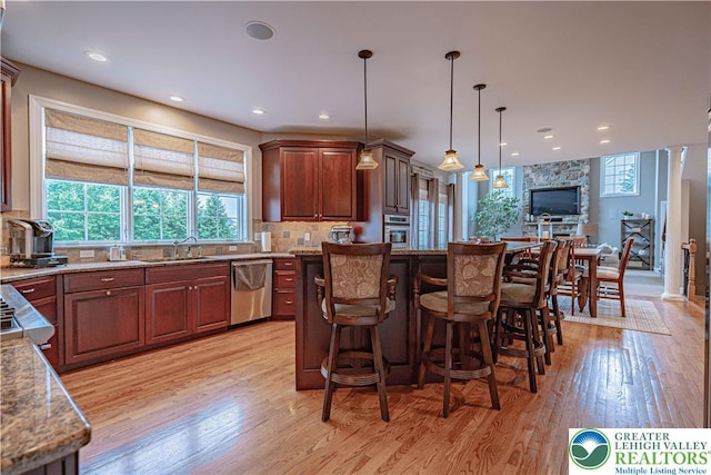 6532 Forest Knoll Ct, Upper Macungie Twp, PA 18106 - kitchen with stainless steel appliances, light wood-type flooring, decorative backsplash, a kitchen breakfast bar, and recessed lighting