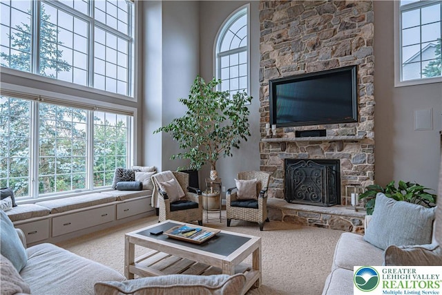 6532 Forest Knoll Ct, Upper Macungie Twp, PA 18106 - carpeted living room featuring plenty of natural light, a fireplace, and a towering ceiling