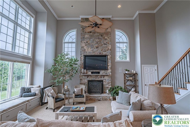 6532 Forest Knoll Ct, Upper Macungie Twp, PA 18106 - living room featuring a fireplace, a high ceiling, ceiling fan, stairway, and carpet floors