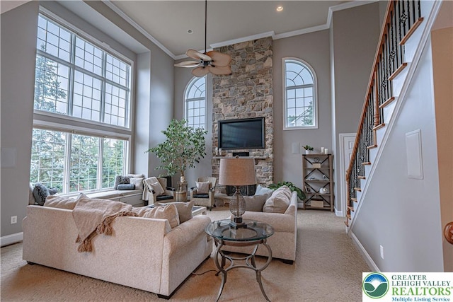 6532 Forest Knoll Ct, Upper Macungie Twp, PA 18106 - carpeted living area with a high ceiling, crown molding, ceiling fan, stairs, and a stone fireplace