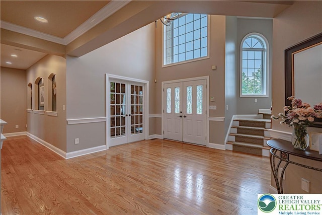 6532 Forest Knoll Ct, Upper Macungie Twp, PA 18106 - foyer featuring french doors, wood finished floors, stairs, and ornamental molding