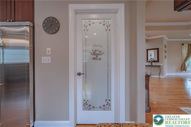 6532 Forest Knoll Ct, Upper Macungie Twp, PA 18106 - detailed view of high quality fridge, crown molding, and wood finished floors